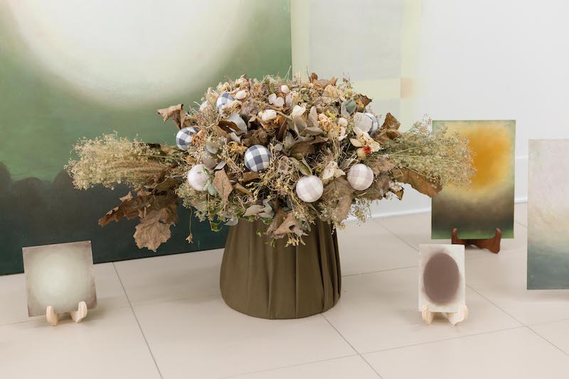 Rosanne Claes, Dream Kitsch: Installation of 13 Abstracts in Front of Mural with Bouquet (detail),KOMPLOT, Brussels, photography by Lola Pertsowsky